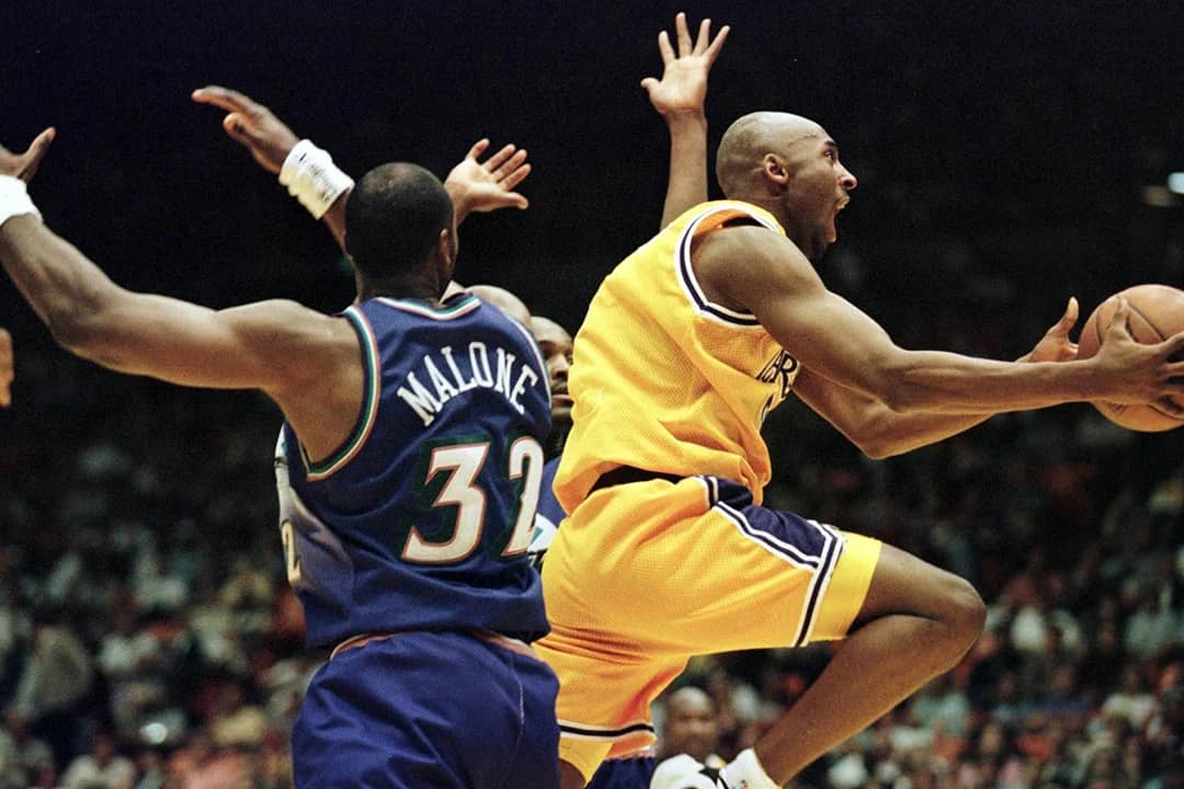 LA Lakers player Kobe Bryant (R) jumps to score during the third game of the NBA playoffs against Utah Jazz in Inglewood, California.